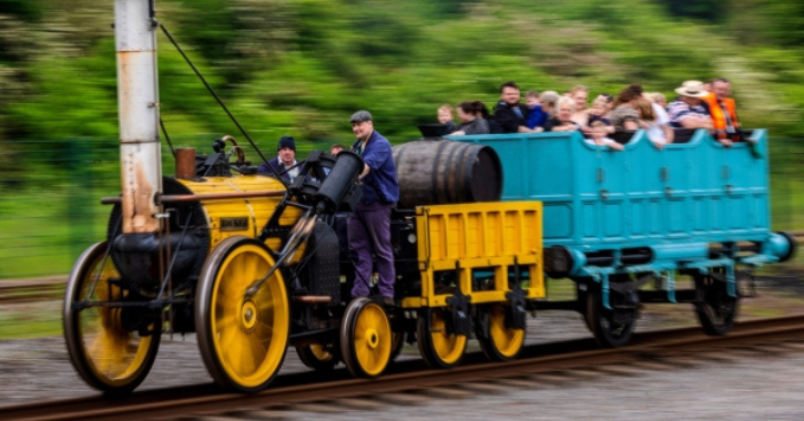 group of people enjoying train ride on historic railway engine at Locomotion.
